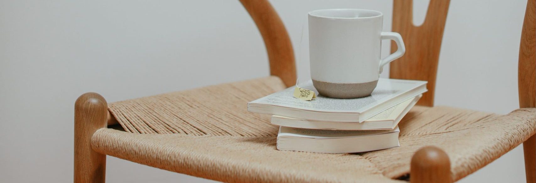 picture of coffee mug and books on chair